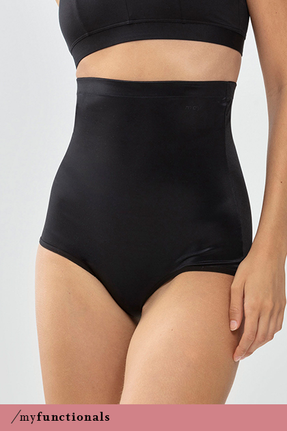 Woman wears black high-waisted briefs with shaping effect from the Cocoon series | mey®