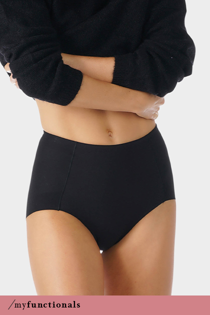 Woman wears black high-waisted briefs with shaping effect from the Nova series | mey®