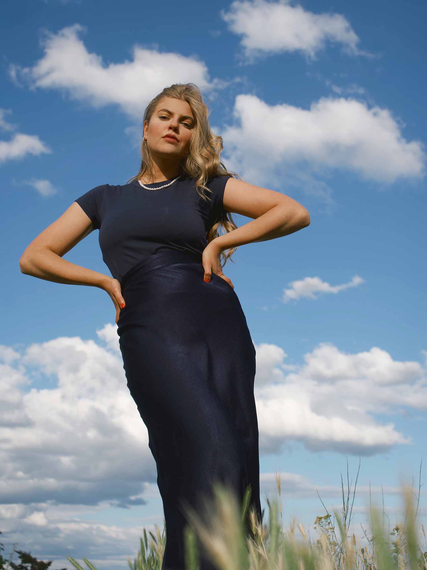 Franziska Nazarenus combines a shiny satin skirt with a high-collared cotton shirt in navy | mey®